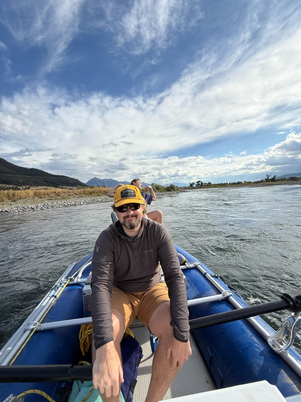 Dawson rowing a raft on a Montana river
